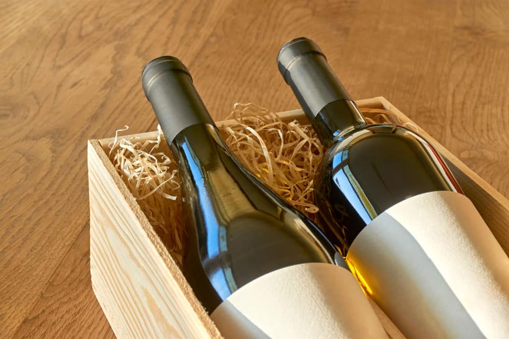 Bottles of red and white wine in wooden gift box