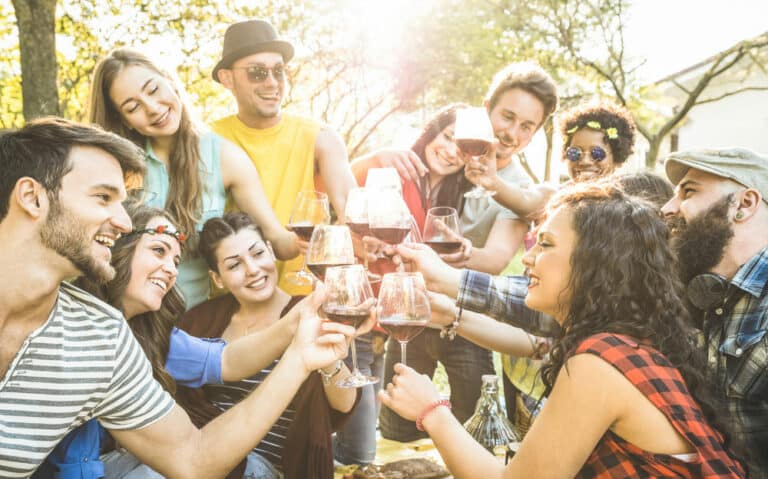 Group of friends toasting red wine
