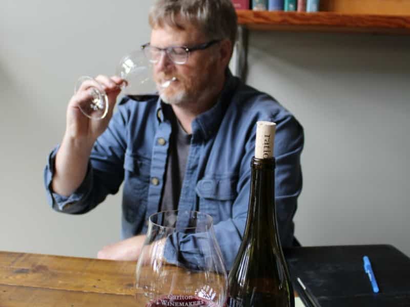 man drinking cup of wine